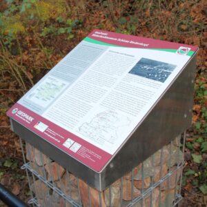 Der Geopunkt in Form einer Gabione mit Grauwacke-Gestein und einer Informationstafel am Schloss in Biedenkopf